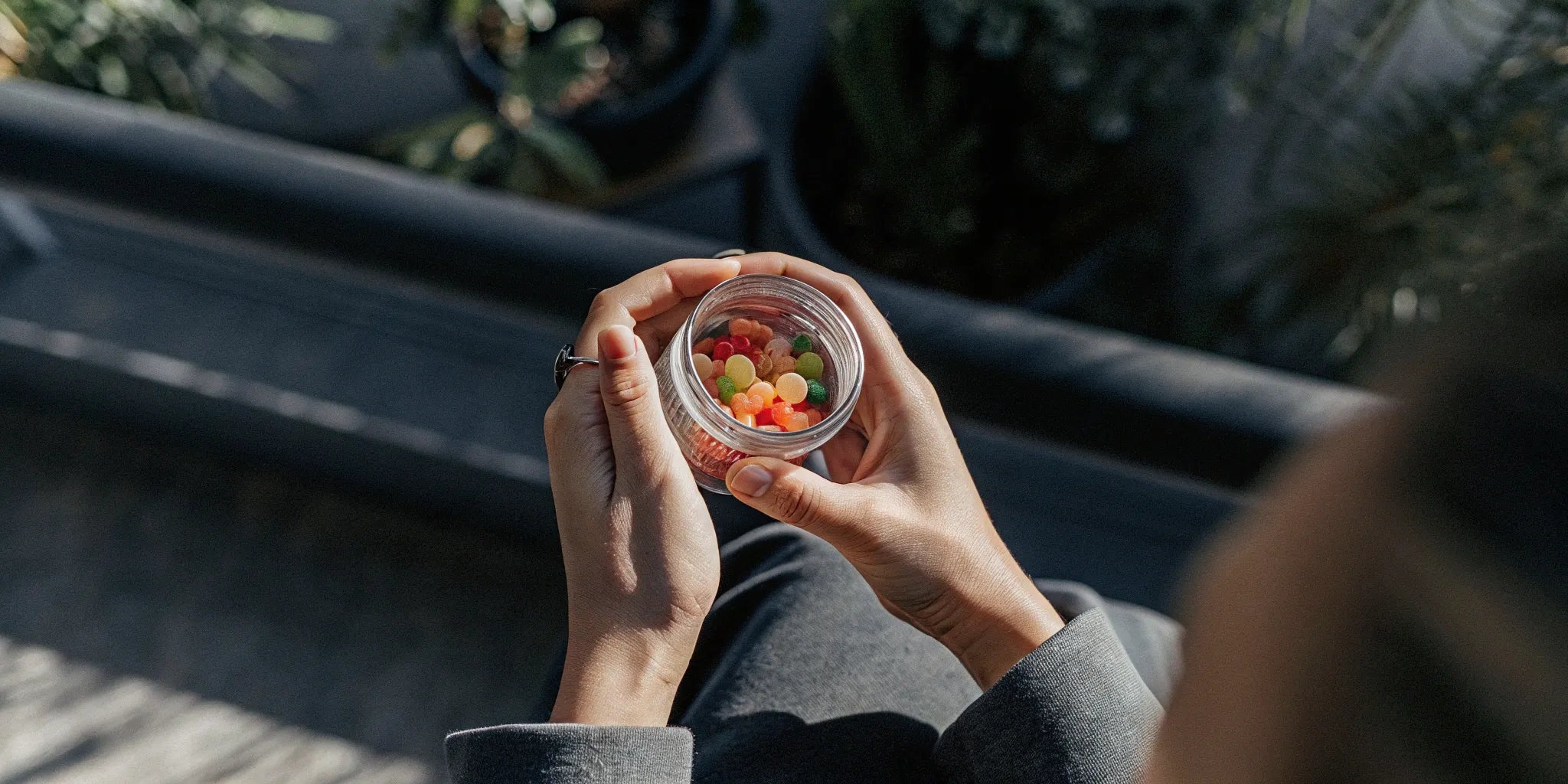 A person holding a jar of the best delta 9 gummies.