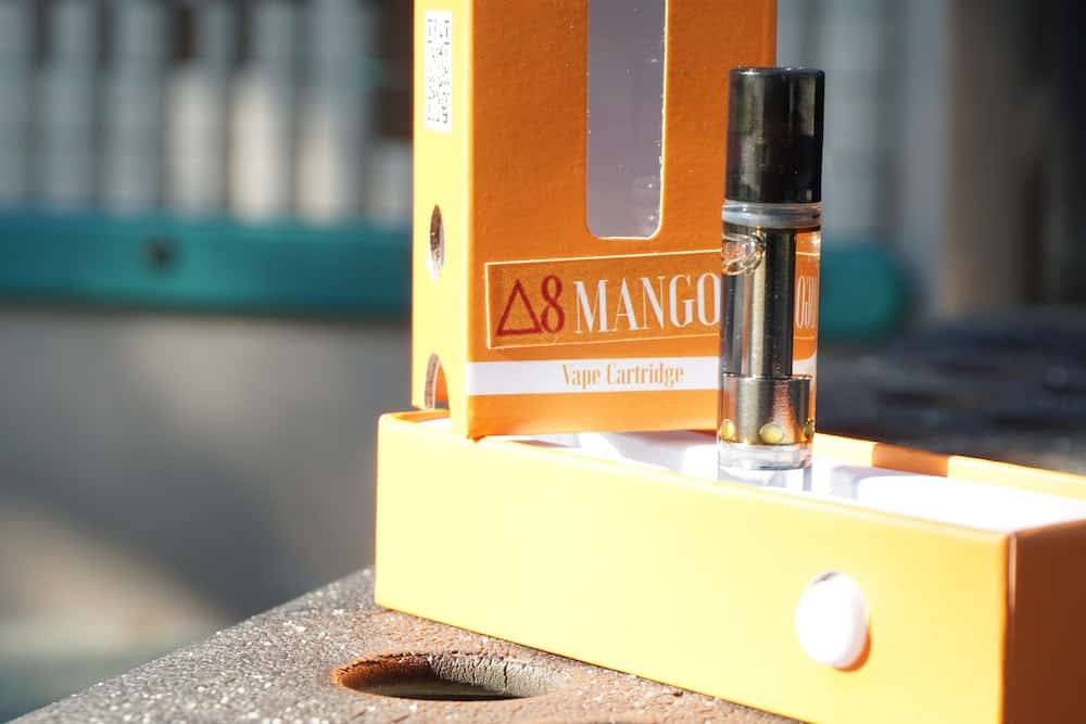 Delta-8 THC Mango Vape Cartridge in packaging