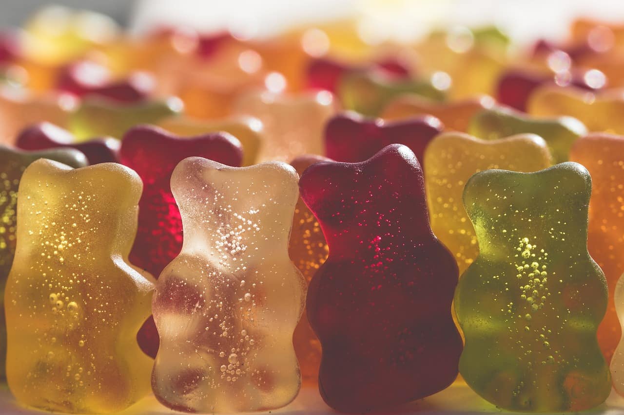 Colorful gummy bears in various flavors, representing Delta 8 THC edibles.