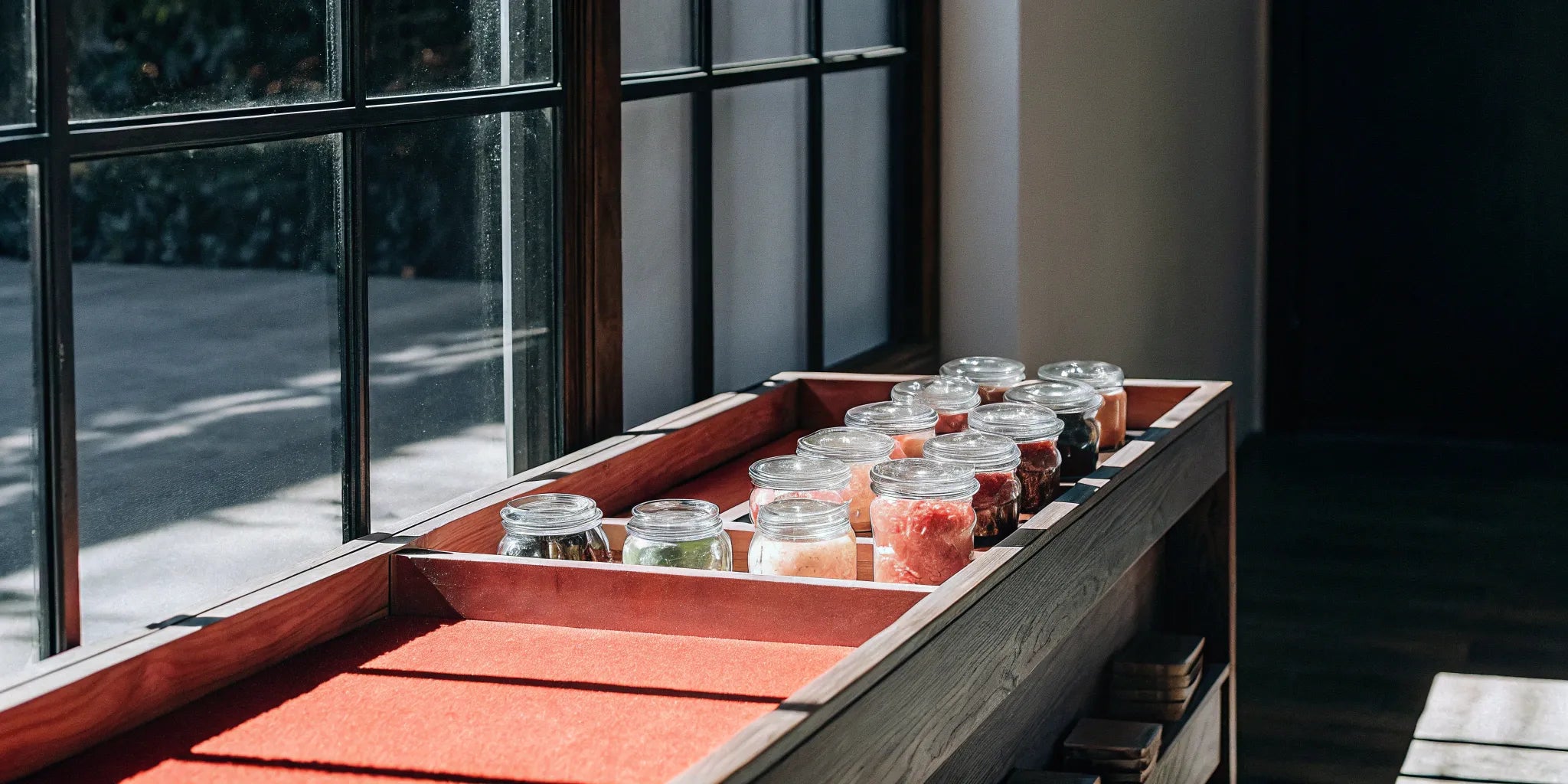 Glass jars of assorted wholesale THC gummies on a retail display.