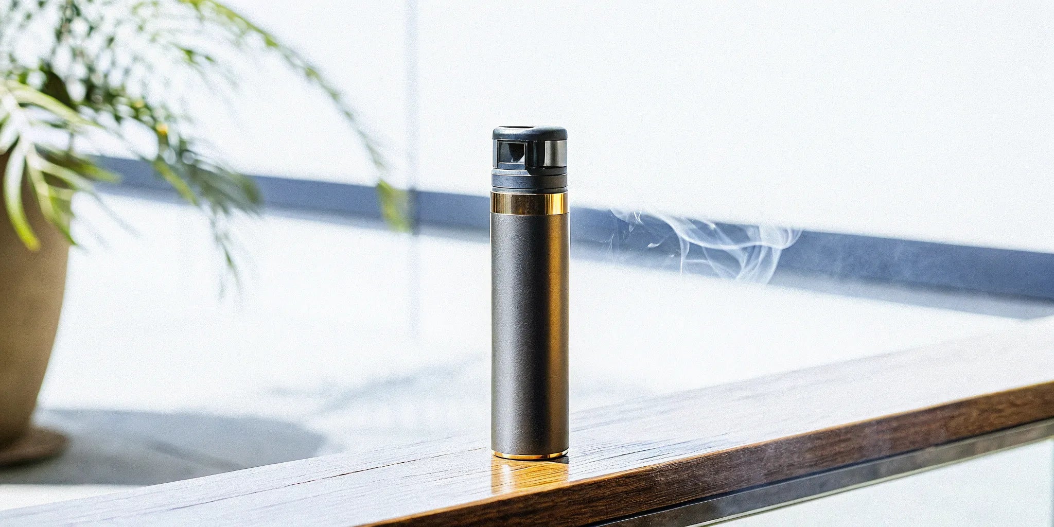 Disposable vape cart on wood surface.