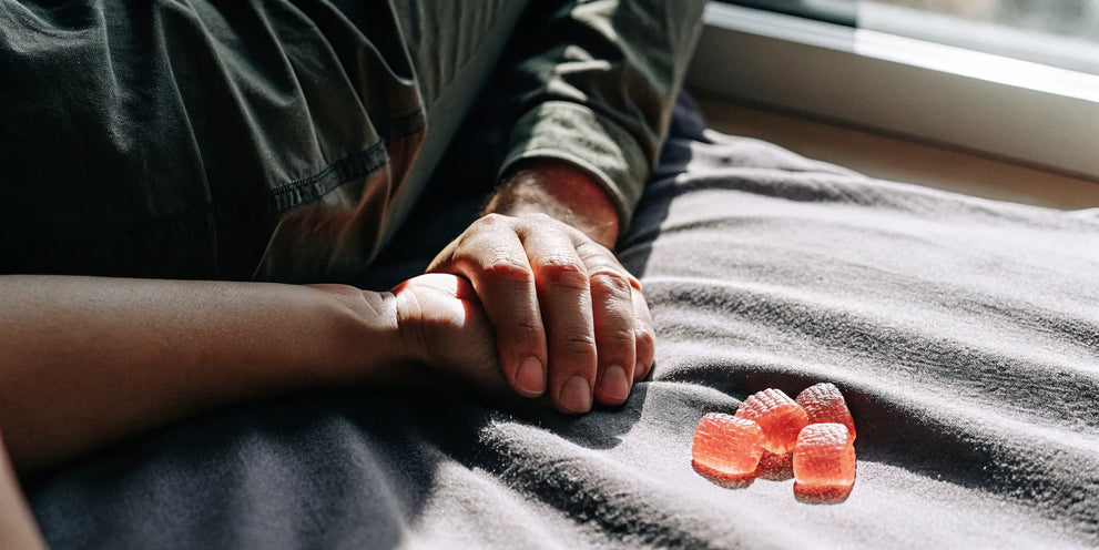 THC gummies for female arousal on bedside table in sunlit room.