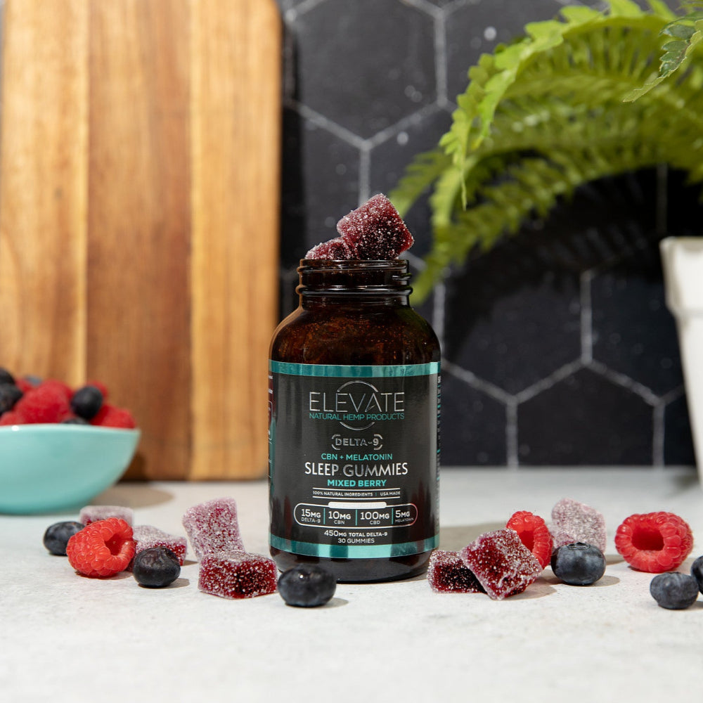 Bottle of 'Elevate' gummy bears on a table with berries and a plant in the background.