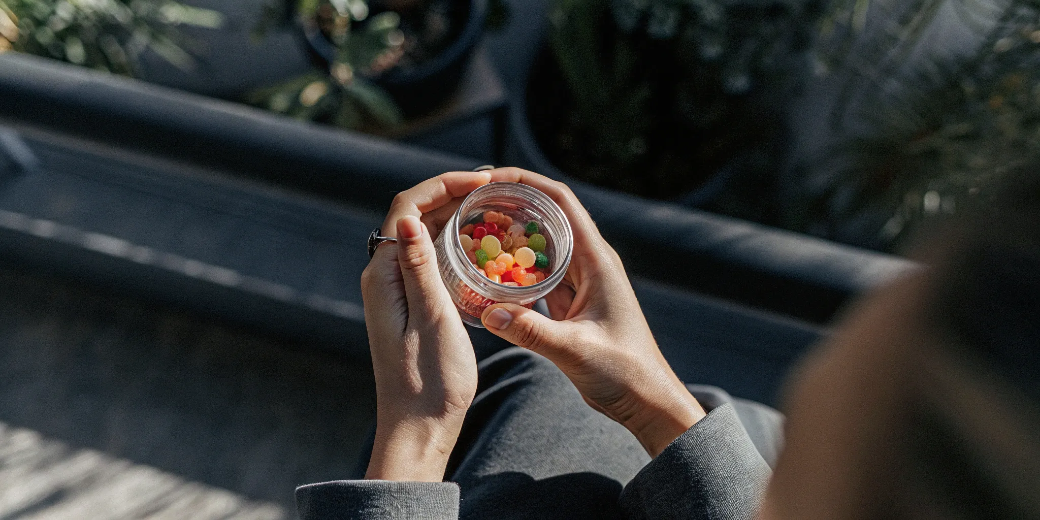 A person holding a jar of the best delta 9 gummies.